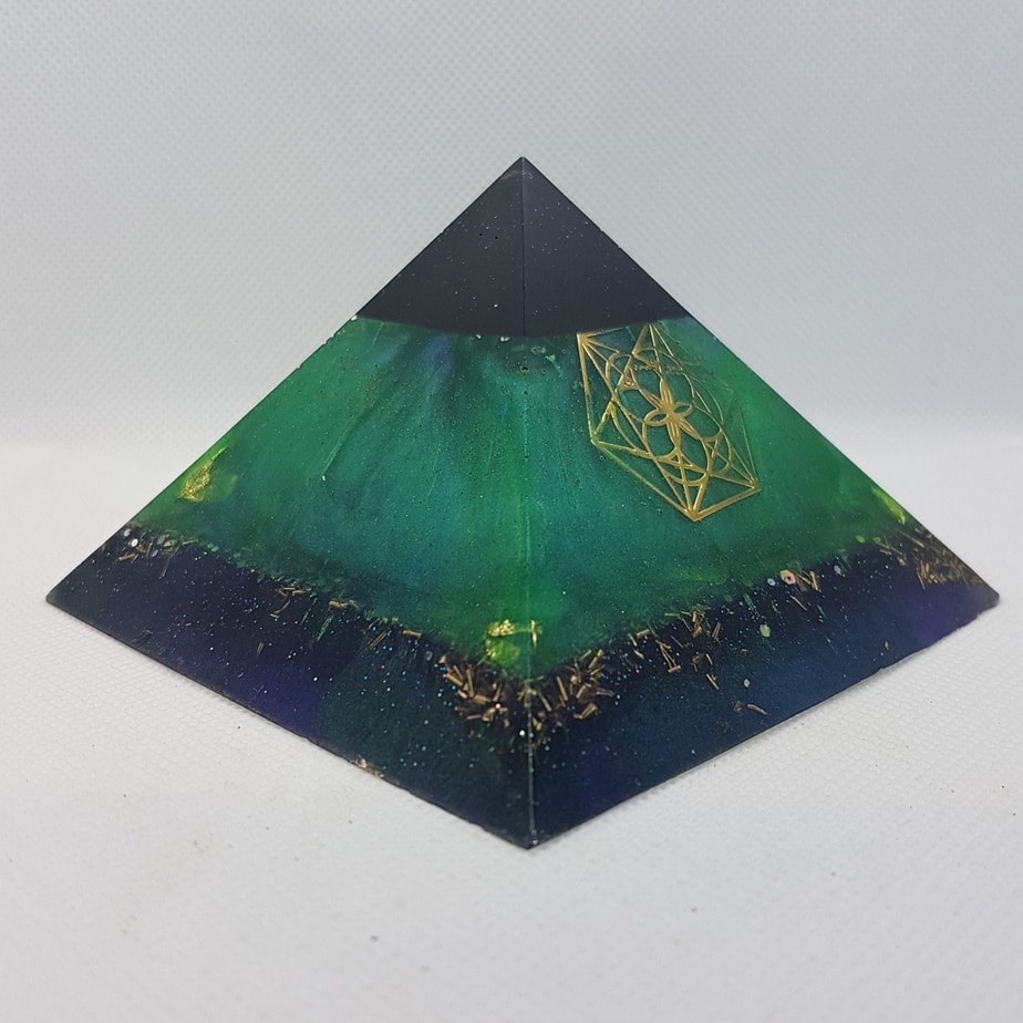 Transformation Orgonite Orgone Pyramid 9.5cm - Sacred Geometry and Shungite, this is a show stopper of power. Within the Shungite is Herkimer Diamonds, a rose quartz chuck and 4 quartz points to assist with emf protection