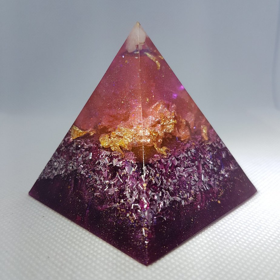 Mauve Perfection Orgone Orgonite Pyramid 6cm -Moonstone, Howlite and Herkimer Diamonds, layer of gold, with clear quartz for clarity and then silver and aluminium as the base.